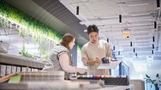 Two architects working together with a model