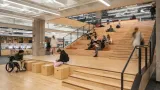 People using staircase/gathering space inside of Student Success District, University of Arizona 