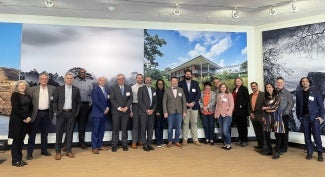 group of people in front of mural