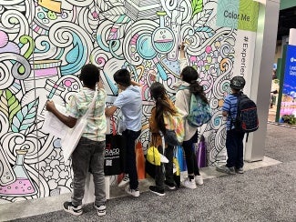 Children decorate a mural
