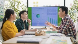 Three coworkers discuss a report