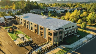 pre-engineered metal building in forested mountain landscape