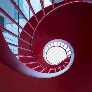 View down into a red spiral staircase 