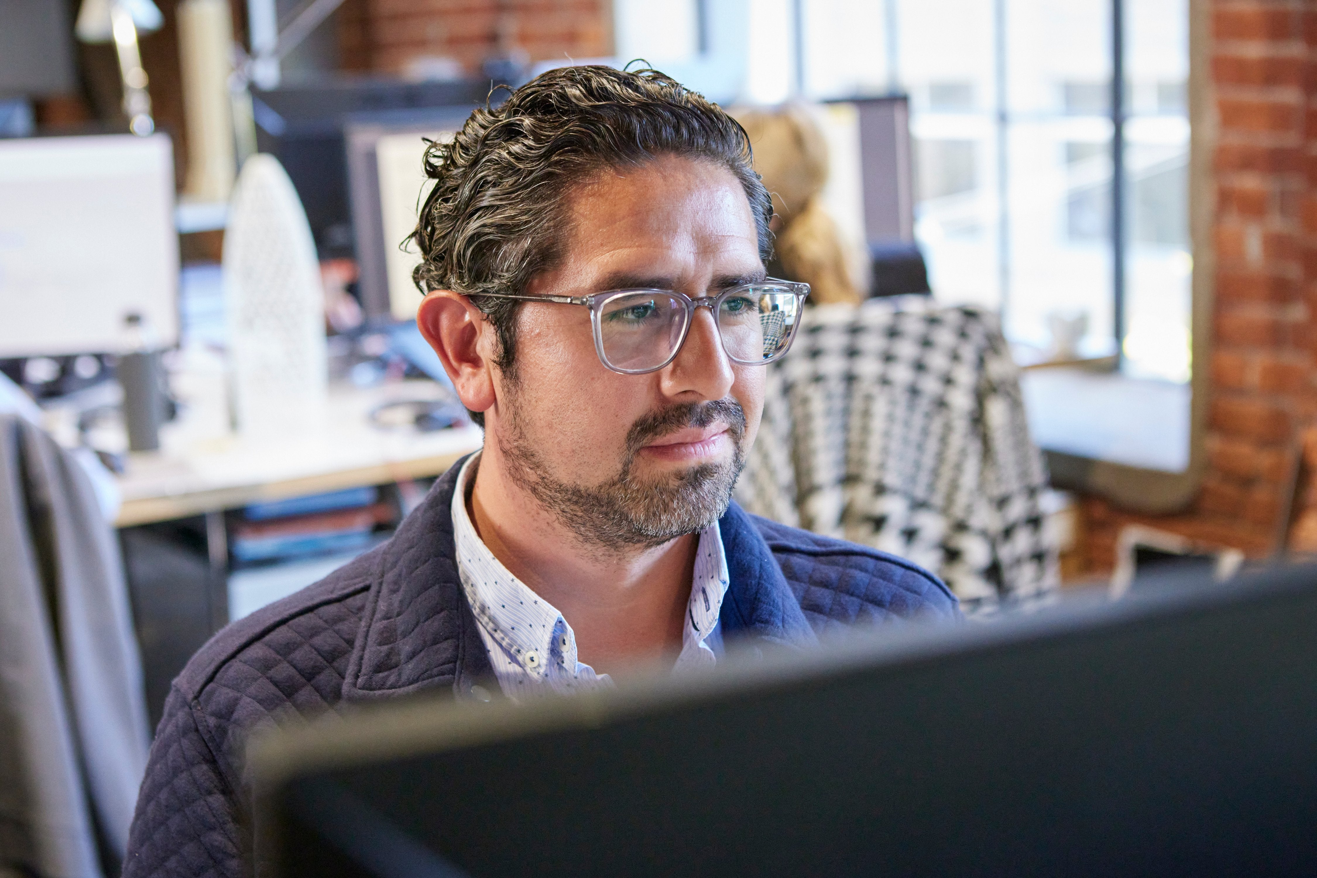 AIA member architect in front of a computer taking an online course.