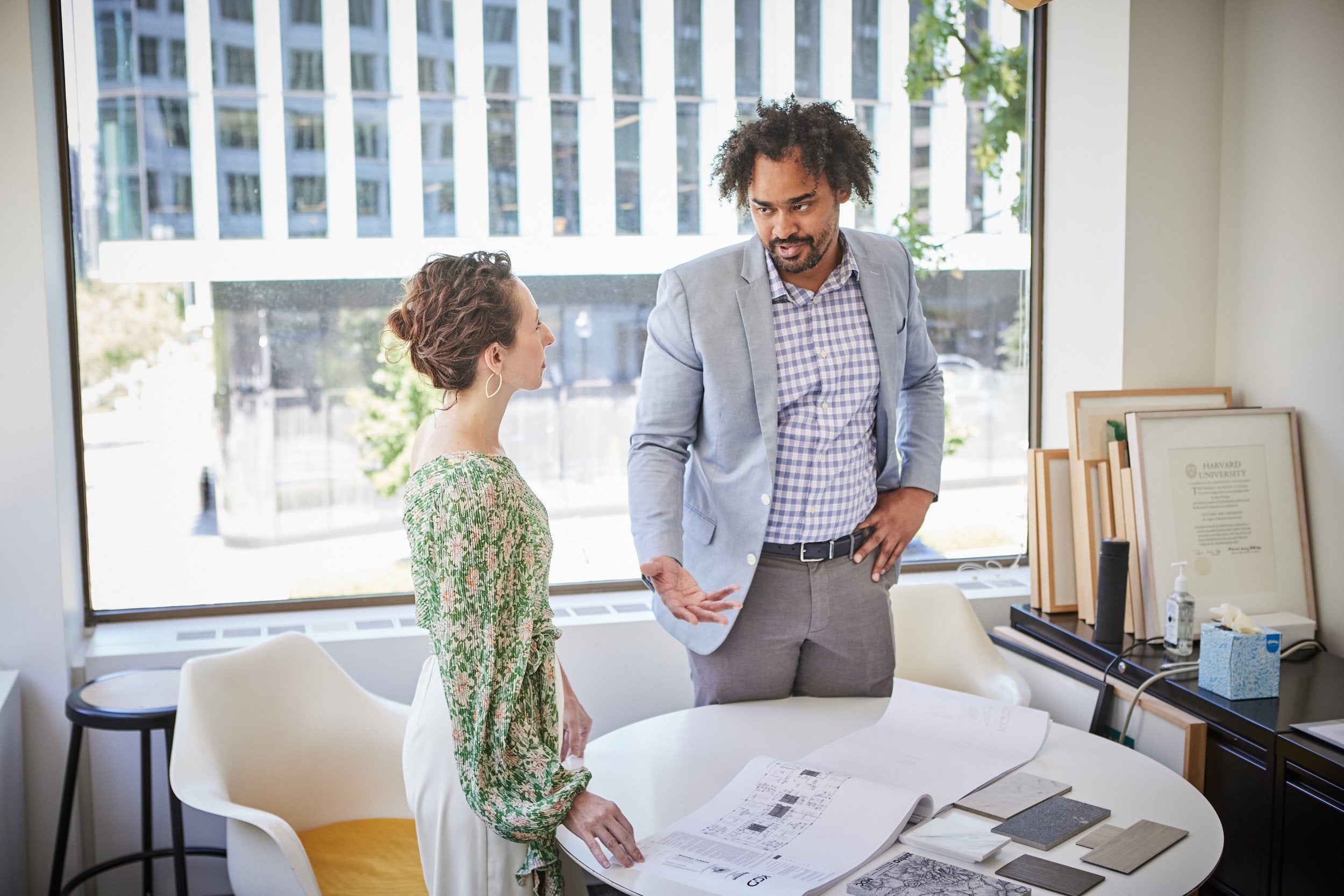 Two architects collaborating on a project in an office.