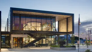 A warmly lit building exterior at dusk