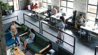 Wide Angle View of a Modern Loft Open Space Office With Businesspeople Working in It