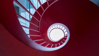 View down into a red spiral staircase 