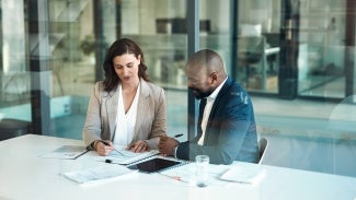 two individuals looking at a document