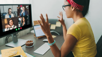 New graduate associate sitting at a desk on a video conference call