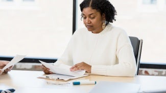 Female manager analyzes documents during meeting