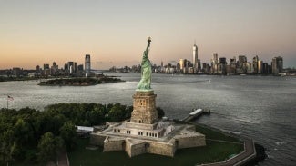 aerial photo of the statue of liberty with the city in the background