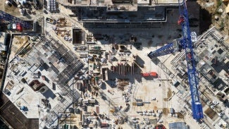 Overhead aerial view of construction cranes at a construction site