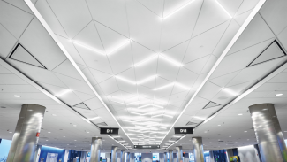 Three overlapping tiers of acoustical ceilings dominate the space with the eye-catching central corridor being the highest tier and the holding/gate areas the lowest.