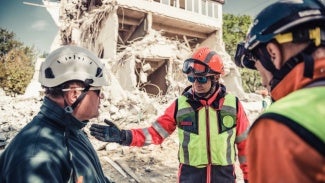 Rescuer search trough ruins of building