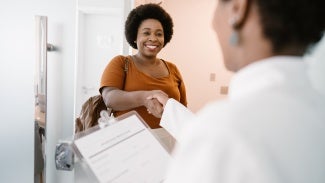 Woman arrives at medical office shake hands