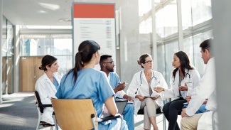 Group of medical professionals sitting in a space talking