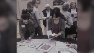 Rania distributing a guidebook for newly displaced refugees in Seattle.