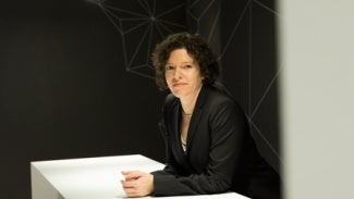 Melissa Marsh leans on a desk