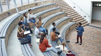 Male teacher lecturing at an outdoor classroom amphitheater 