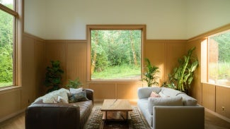 Interior of Silver Residence, a living room with two sofas and three Andersen windows.