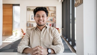 architect David Zuniga sits at a desk