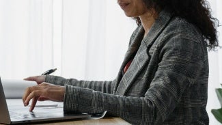 Woman working at desk on her computer