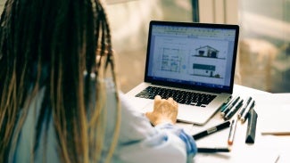 Woman working at desk on her computer
