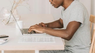 Man working on laptop at table