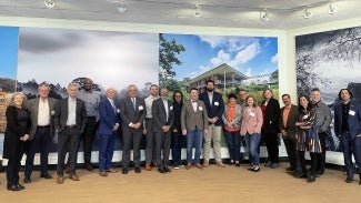 group of people in front of mural