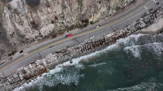 aerial view of malibu coastline with charred residential remains