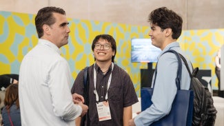 Attendees speaking to their mentor at conference