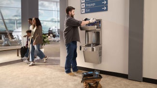 A person using a water fountain