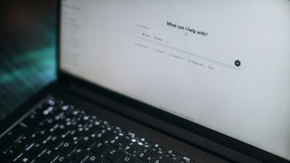 Laptop open showing user using artificial intelligence