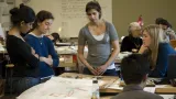 Woman collaborating with students in a classroom