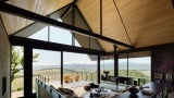 Three Gables home interior living room looking out to deck and rolling hills