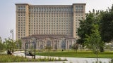 exterior of Michigan Central Station at day; tree in foreground