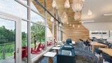 Library interior; couches look out toward large windows and view of the porch and outdoors