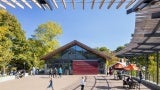 View from under overhang toward Conservation Pavilion where children are playing.