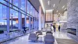 Interior lobby of Allegheny Health Network Wexford Hospital at sunset with people talking