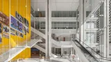 MAIN ATRIUM LOOKING NORTH WITH PUBLIC ELEVATOR CORE ON LEFT WITH LOCAL HERITAGE IMAGES. CONVENIENCE STAIR AND ESCALATORS LEAD UP TO HIGH TRAFFIC COURTS ON 2ND FLOOR AND COURT SERVICES ON 3RD FLOOR