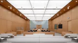 CEREMONIAL COURTROOM WITH BEECH VENEER WALLS AND MILLWORK, LUMINOUS CEILING, AND WHITE SOLID SURFACE PUBLIC SEATING