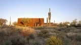 Pima Dynamite Trailhead during sunset, with cacti in the foreground.