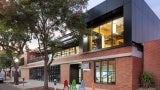 View to new DPR entry and level 2 mass timber addition, exterior façade restored to original building materials.