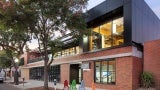 View to new DPR entry and level 2 mass timber addition, exterior façade restored to original building materials.