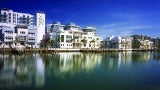 a series of multifamily residential buildings along a riverfront.