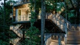 building with multiple staircases is surrounded by lush green environment
