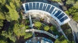 Outdoor learning spaces and an exterior canopy walk integrate the building with the restored oak woodland ecology.