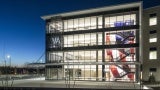 AT NIGHT, THE BUILDING'S MULTI-STORY WALL GRAPHIC DEPICTING THE AMERICAN FLAG TAKES CENTER STAGE AND IS TRANSFORMED INTO AN ILLUMINATED FEATURE.