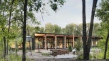 The building, sited near the marshy wetland of Westwood Lake, captures roof rainwater to minimize impact on the watershed.